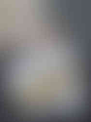 Young child holding an AdventuEscape sign on a porch, representing the early days of the escape room business when it first opened.