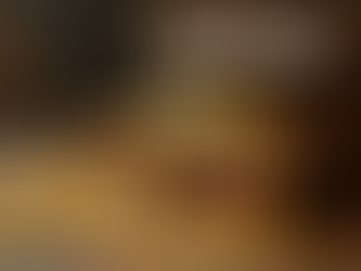 A golden rimmed treasure chest partly opened with gold coins spilling out