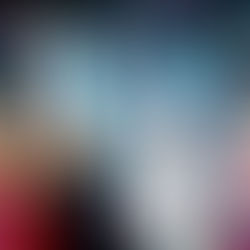 Four people celebrating, smiling joyfully under colorful confetti. They're dressed in festive attire with party hats, against a vibrant, lit backdrop.