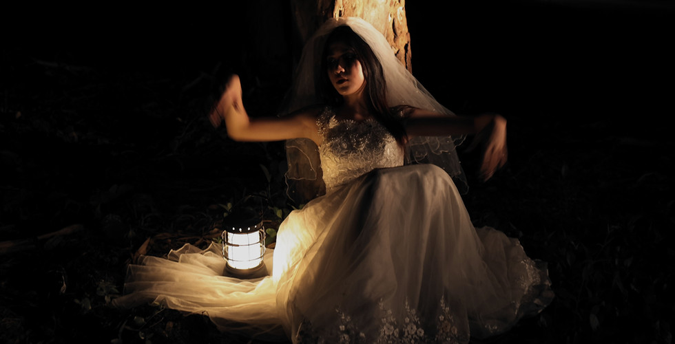 Ghostly image of a young girl holding a lantern