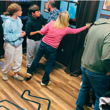 group collaborating to investigate clue in immersive adventure environment