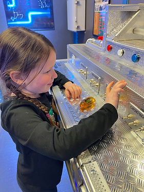 young girl playing with time machine console in a family-friendly escape room in Windsor Locks, CT