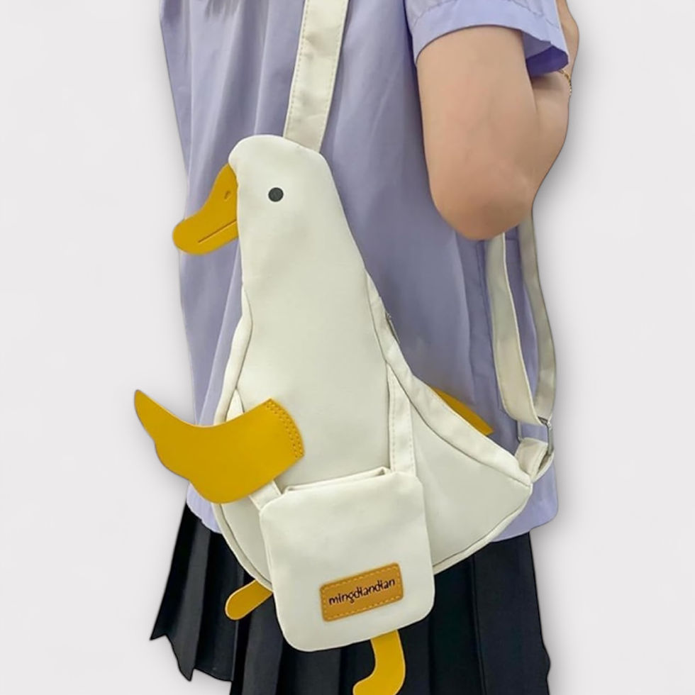 Person wearing a cute white duck-shaped crossbody handbag with yellow beak and feet, novelty animal shoulder bag, styled with a lavender t-shirt and black pleated skirt.