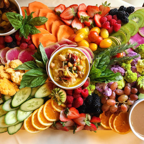 Colorful crudité board with fresh vegetables and house-made dips by The Charcuterie Lady