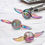 Miniatura: Rainbow-colored spinning tops with wings
