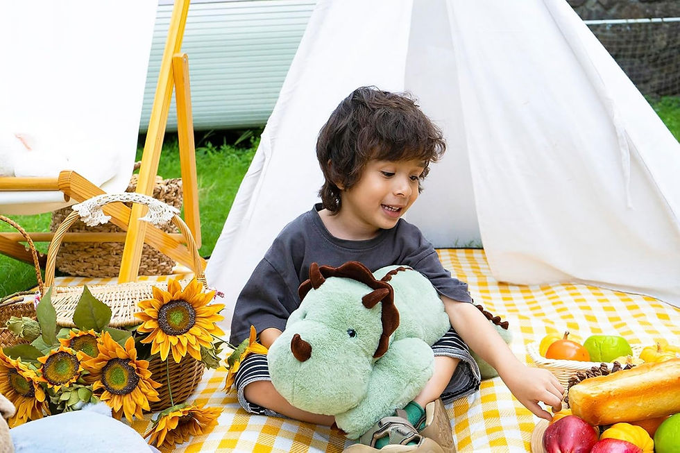 Miniatura: Child playing with plush dinosaur toy inside teepee