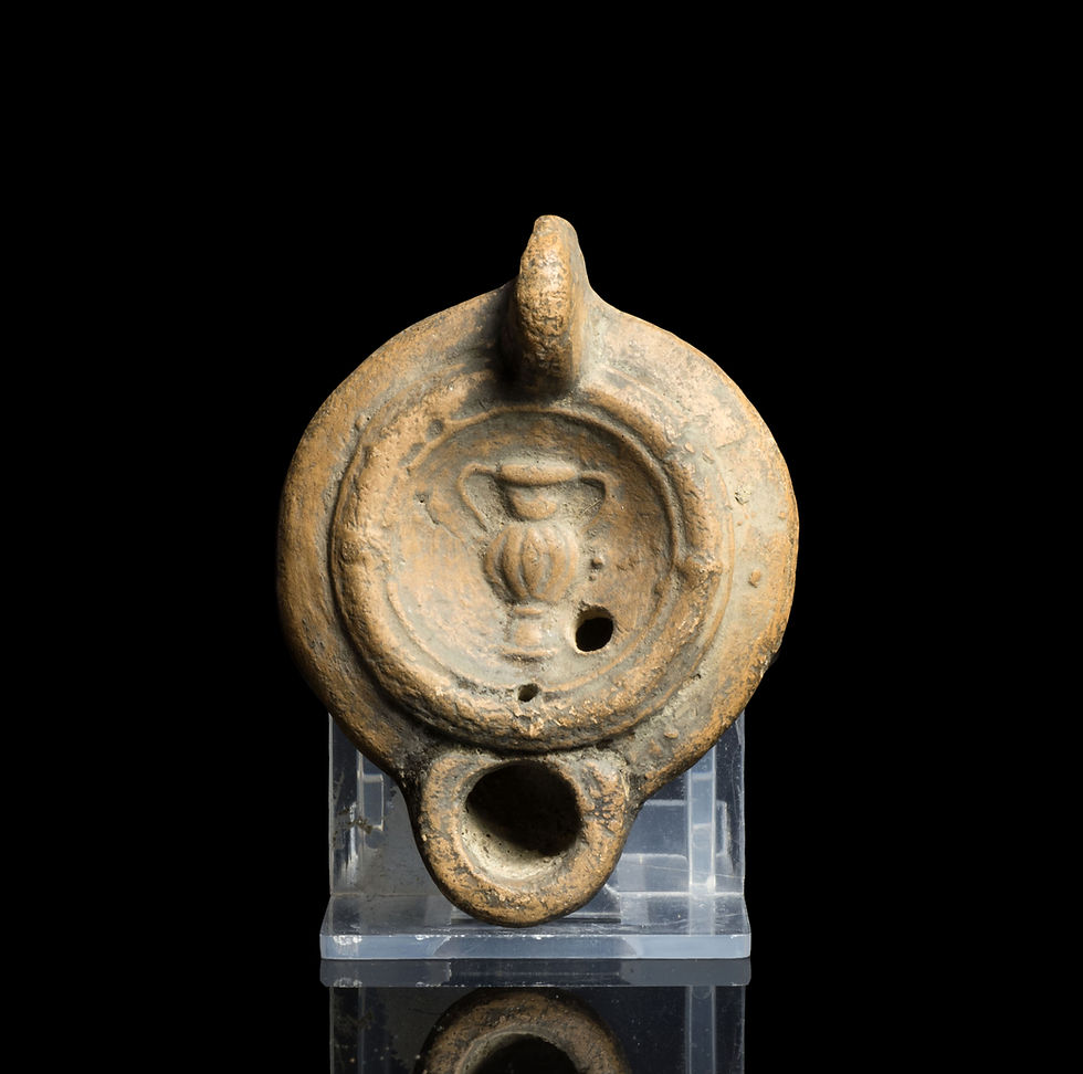 Ancient Roman oil lamp with kantharos depicted on discus