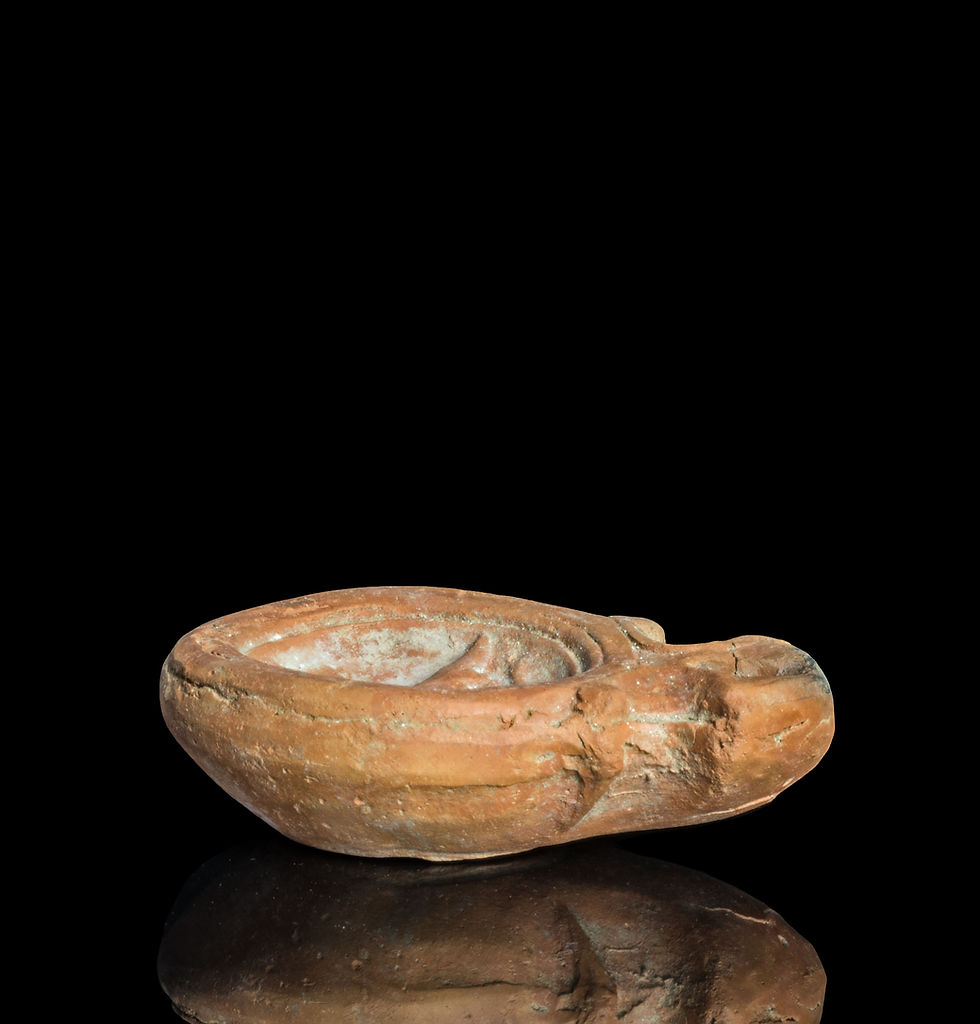 Side view of Ancient Roman oil lamp with crocodile