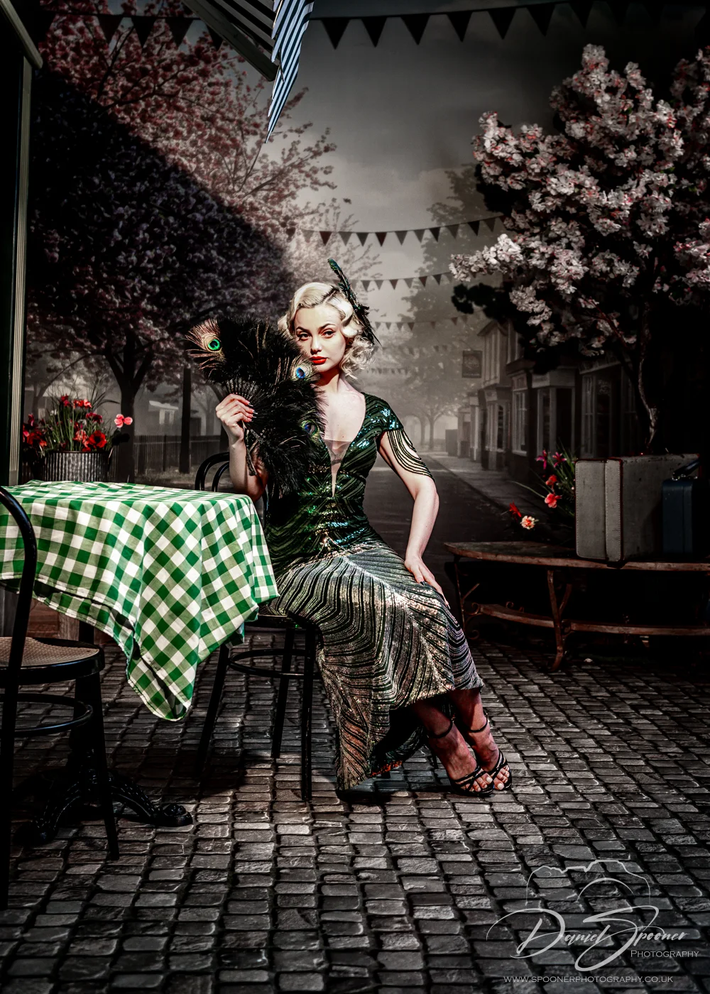Roxana Pamela in 1920's fashion with Peacock fan sat infront of diner moody colours