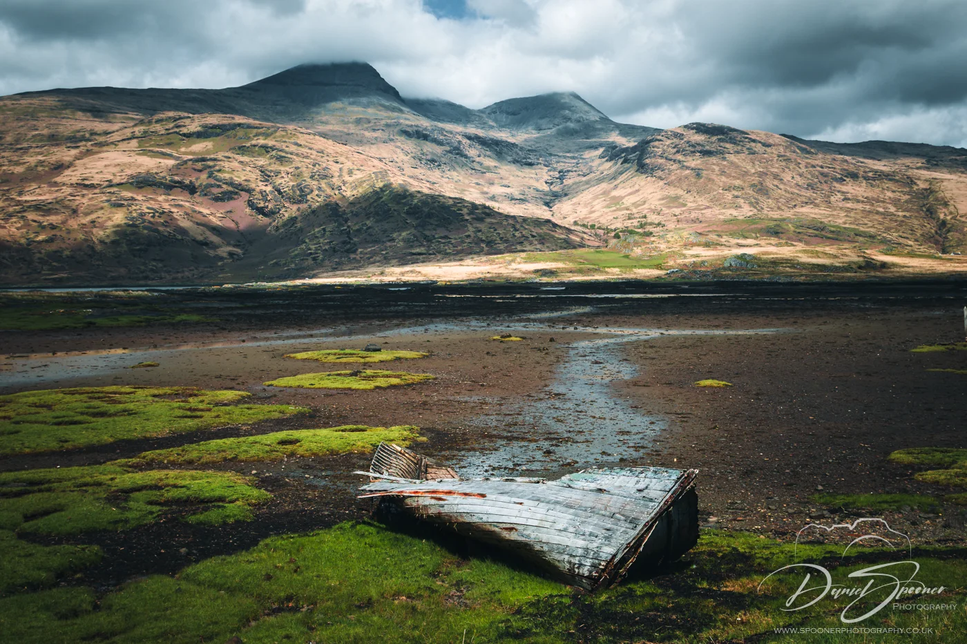 Old wooden boat decomposing along the shore of Loch Scridain.