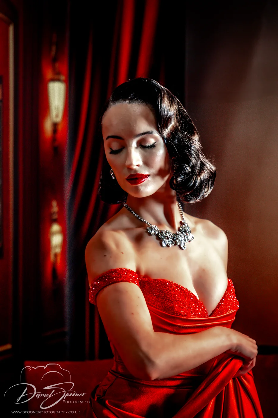 Sarah Kerr Model in Red Dress Photography Show 2025 Head tilted to right, left on the image. Classic 1950's