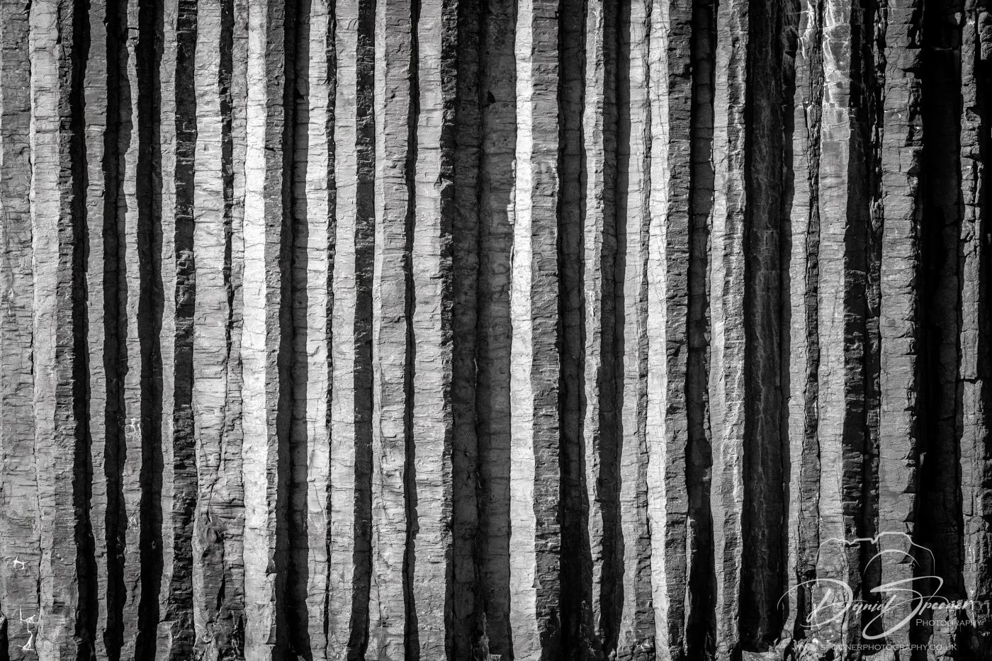 Detailed black-and-white image of tightly packed vertical basalt columns on Staffa, highlighting texture and pattern.