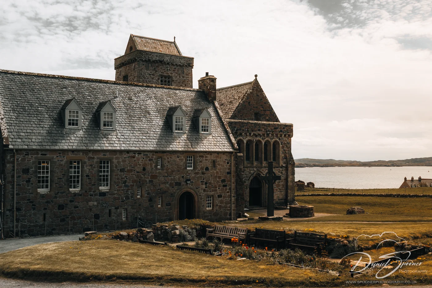 Stone structure of Iona Abbey under dramatic cloudy 