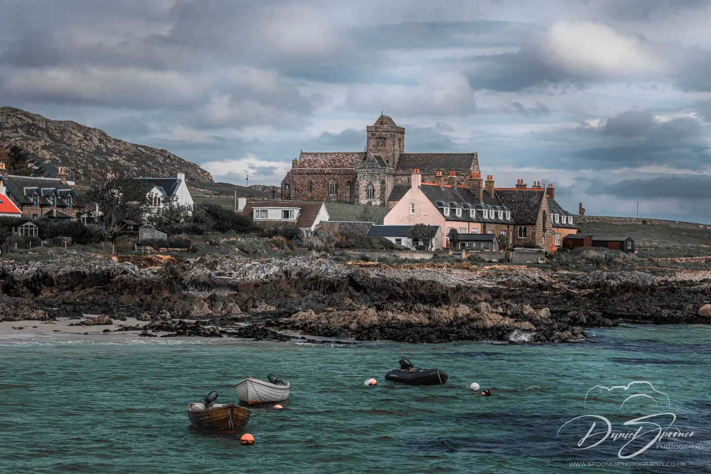 Stone structure of Iona Abbey under dramatic cloudy 