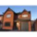 Detached home with grey window and door installations