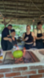 Guests cooking together over open fire at Alma Del Rio