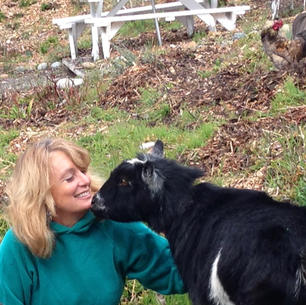 Cynthia Brian with her goat in the garden