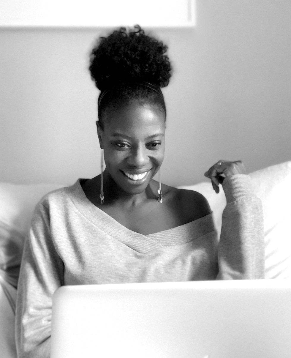 Ionan Marie Designs owner & artist at work on laptop.