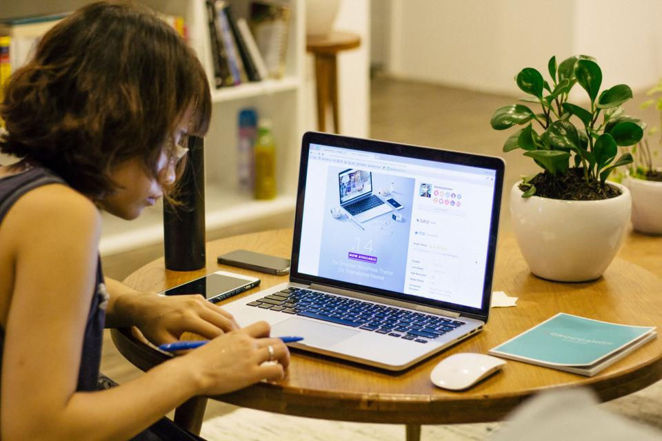 High school student studying at a laptop at home