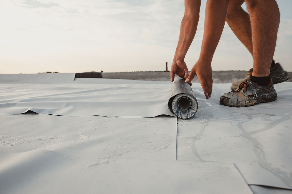 Worker applies pvc synthetic membrane roller on roof very carefully.jpg