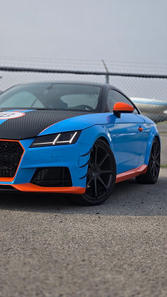 Audi TT with custom blue, orange, and carbon fiber vinyl wrap by Pure Bespoke