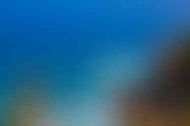 Coastal view of bright blue ocean and rocky cliffs; Lisbon, Portugal. Jeff Bana Photography