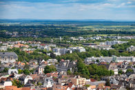 Aerial view of a city with buildings and green trees. Jeff Bana Photography