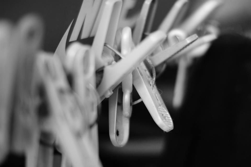 White clothes hangers with the Nike logo, black and white background.