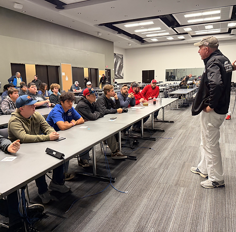 volunteer speaking to a group of students