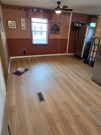 Dining area with new flooring installed during kitchen renovation project.