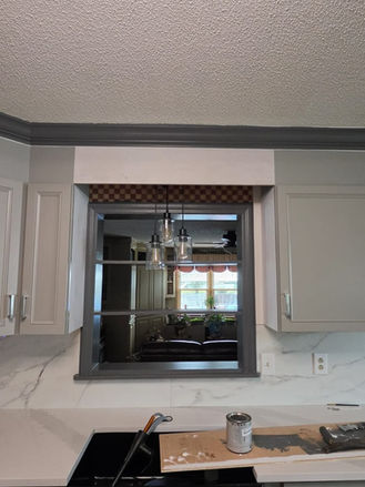 New farmhouse sink, quartz countertops, and gray cabinets installed during kitchen renovation project.