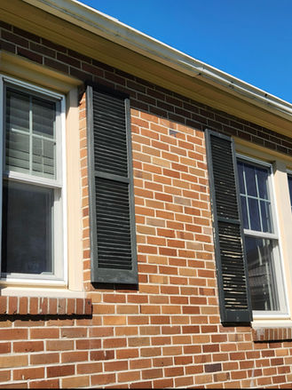 Exterior windows shutters before restoration, showing faded paint and weathered surfaces prior to sanding and repainting.