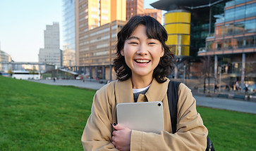 image-korean-girl-with-happy-face-walks-around-town-with-student-tablet-stands-street.jpg
