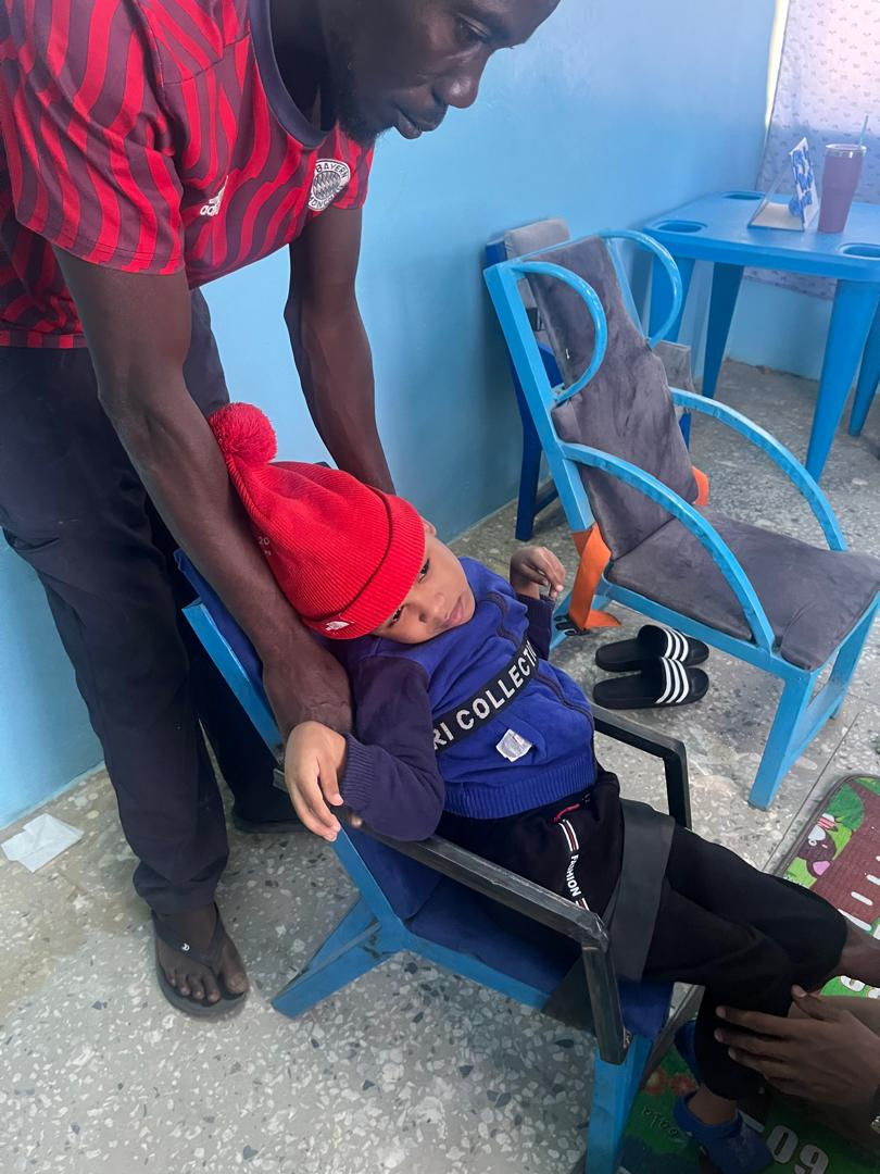 This is little Khalil in his new chair built just for him