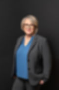Profile photo of Julianne Vandergrift looking at the camera in dark suit