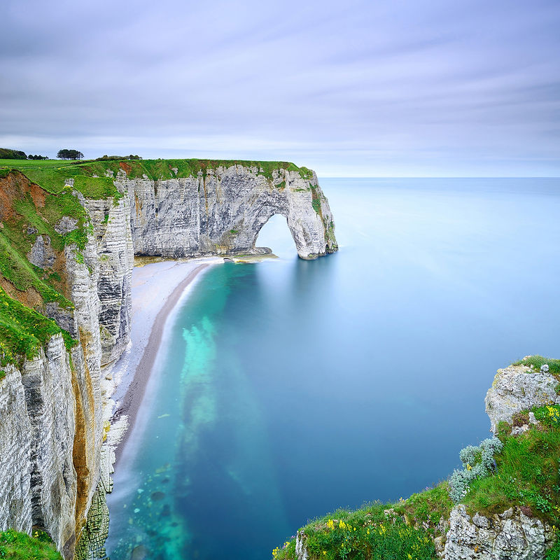 Etretat, la Manneporte natural rock arch, cliff and beach. Long exposure photography. Normandy, France.