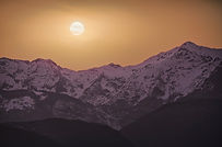 Apuane alpi or Apuan alps snowy mountains in winter in a red sunset. Garfagnana, Tuscany, Italy.