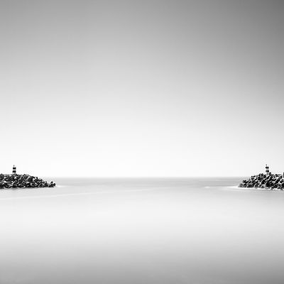 Black and white long exposure photography of Nazaré marina entrance, Portugal.