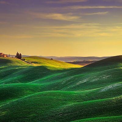 Tuscany, rural landscape in Crete Senesi. Rolling hills, countryside farm, cypress trees and green field at sunset. Siena, Italy, Europe.