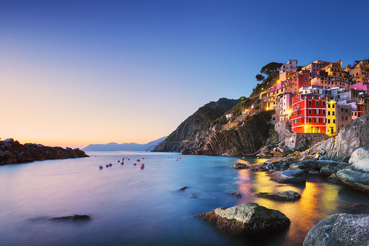 Riomaggiore, cape and rocks after sunset. Seascape in Cinque Terre, Liguria Italy Europe. Long Exposure.