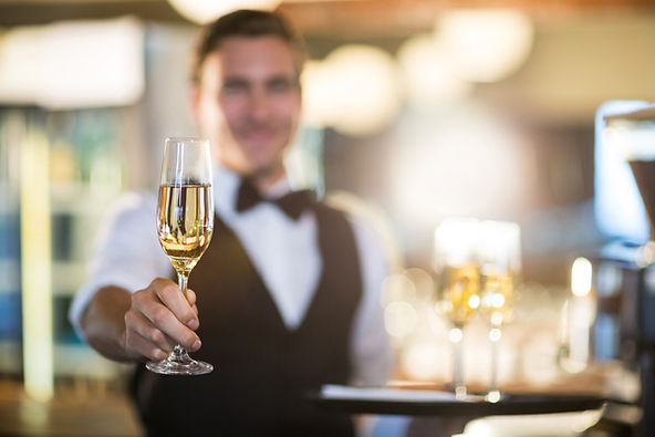 waiter-offering-a-glass-of-champagne-2021-08-28-22-14-30-utc.jpg