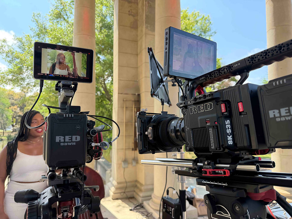 Eye-level view of a professional video camera setup with softbox lighting focused on a single interview chair
