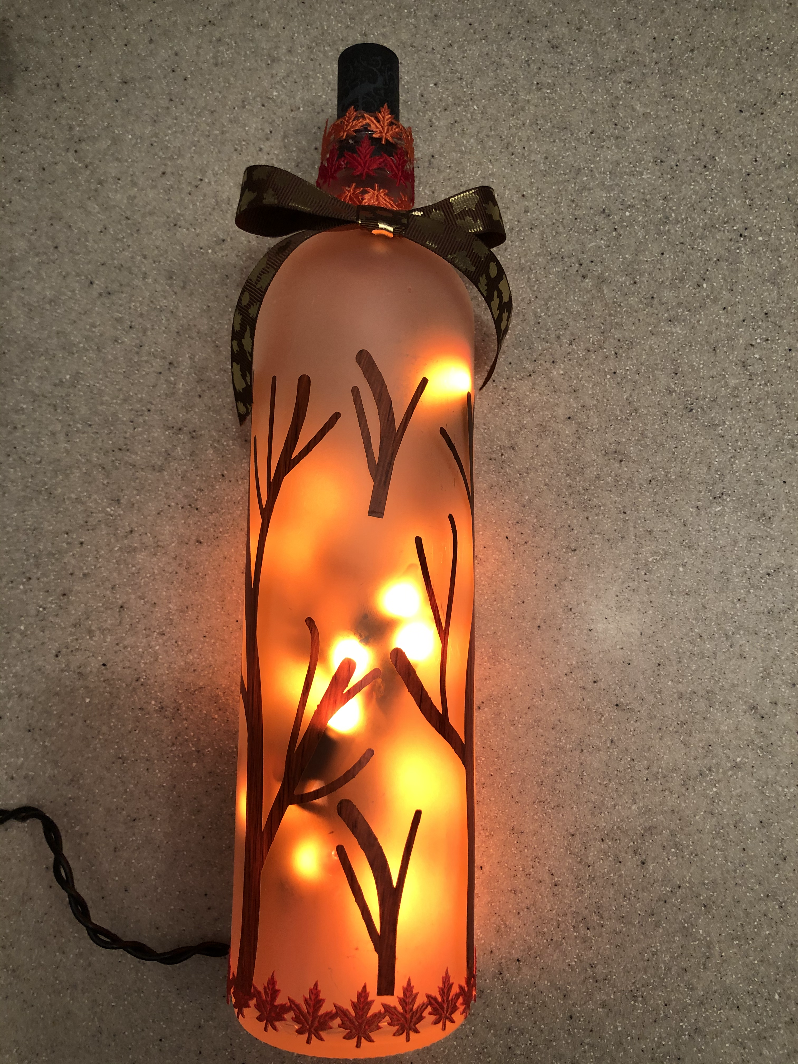 Frosted Bottle with Trees / orange light