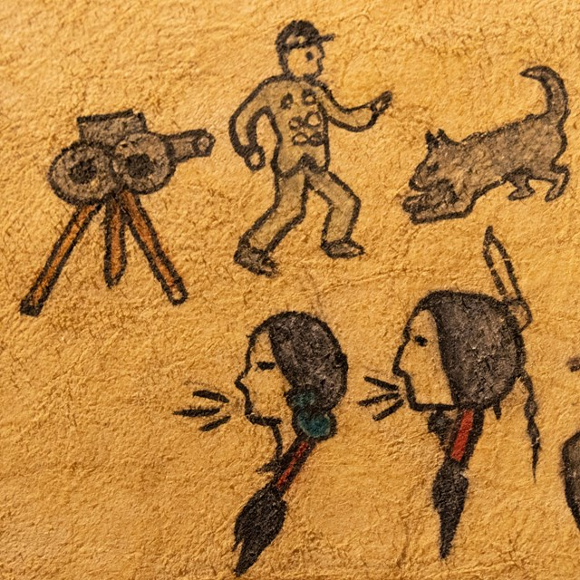 a photo of old drawings on a rock wall