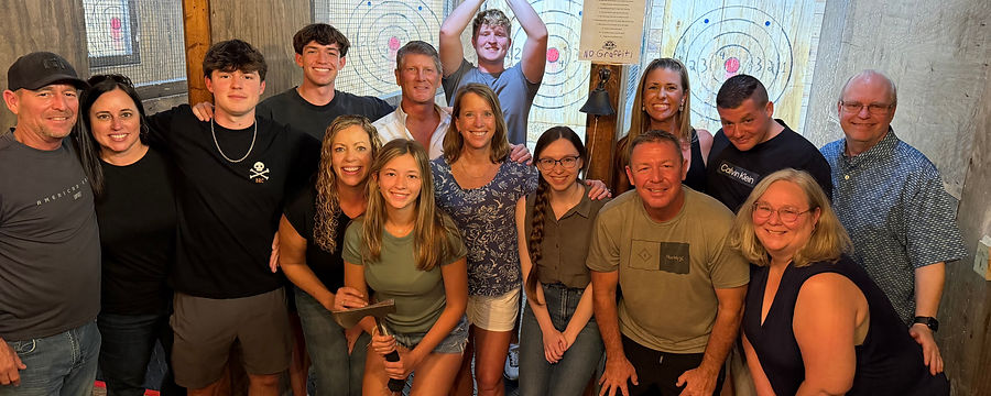 Group of friends celebrating together in the axe throwing lanes at Lumber Axe in Fort Myers