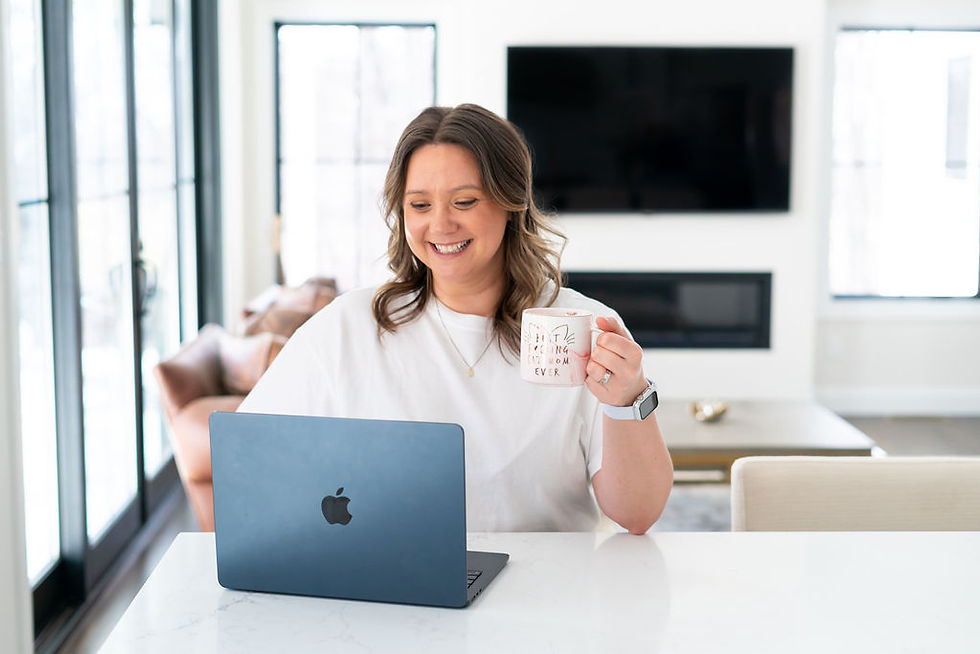 A woman working on her computer drinking coffee