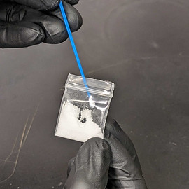 Amplifi ID operator prepes Trace Scan by removing a small amount of drugs from a bag