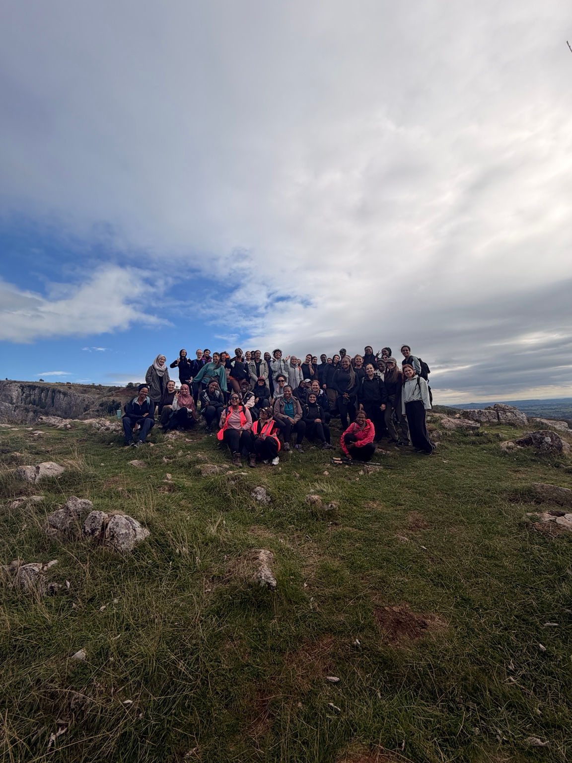 The group together on a hilltop