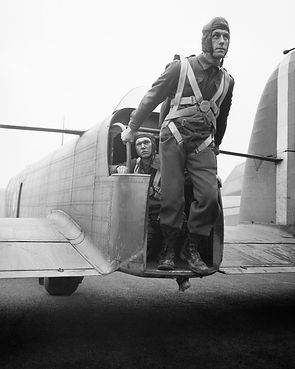 A_parachute_soldier_demonstrates_the_exit_point_from_the_tail_of_a_Whitley_bomber_converte