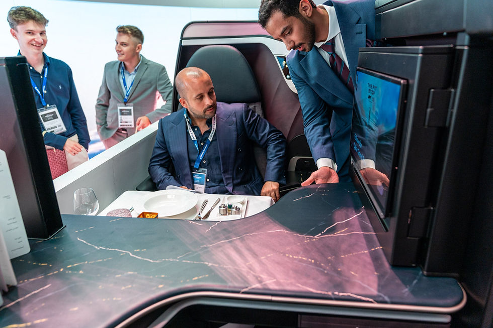 A man observing the new features of Qatar Airways new seats.